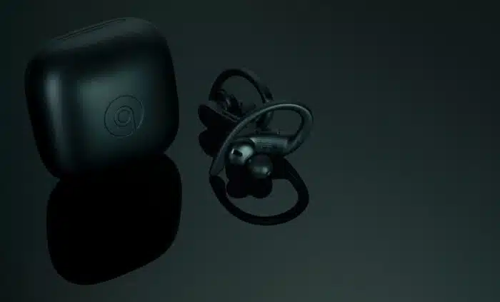 Powerbeats Pro - Totally Wireless Earphones - Black and charging case. Workout earphones on dark background.