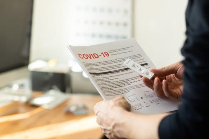 COVID-19 Rapid test cassette for coronavirus. Man holding a rapid testing kits. Coronavirus antibody test. - antibody blood tests