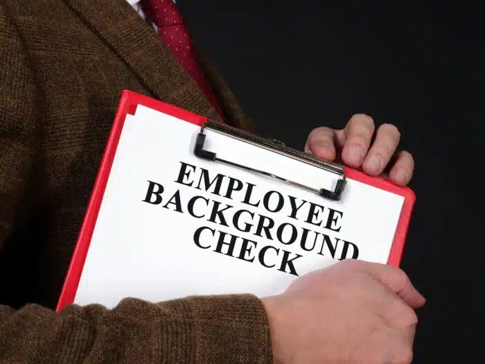HR manager holds Employee background check report - first advantage settlement - background checks lawsuit - FCRA settlement