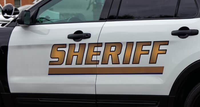 Side view of Sheriff's car door with SHERIFF text symbol - Missouri Sheriffs' retirement system - court fees - missouri settlement