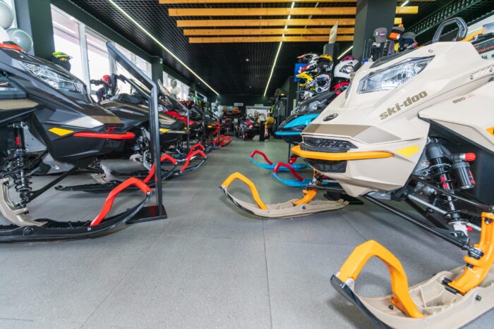 New BRP snowmobiles of 2022 model year with BRP Lynx and Ski-Doo logos set out for sale in showroom
