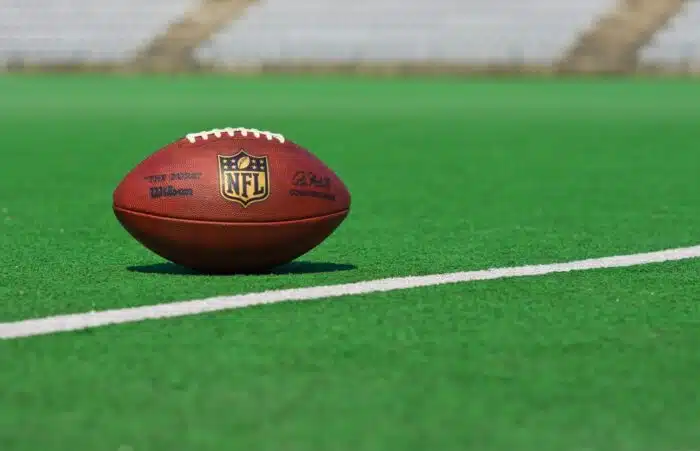 official ball of the NFL football league , the Duke on grass turf background , product shot