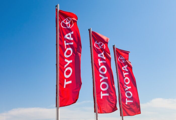 Official dealership flags of Toyota against the blue sky
