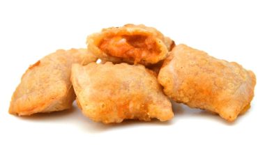 A serving of bite size pizza rolls isolated on a white background.