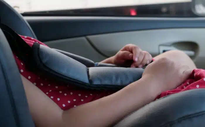 Close up of a child in a vehicle booster seat, representing the Britax settlement.