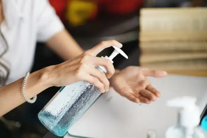 women washing hands with alcohol gel or antibacterial soap sanitizer