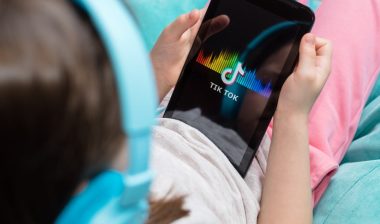 tablet in kids hands with Tik Tok icon