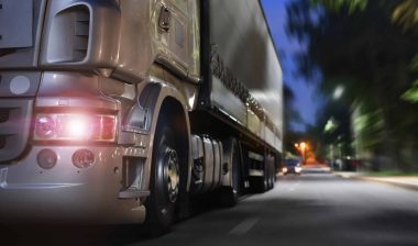 truck drives on a night road; concept Commercial Trucking Accident
