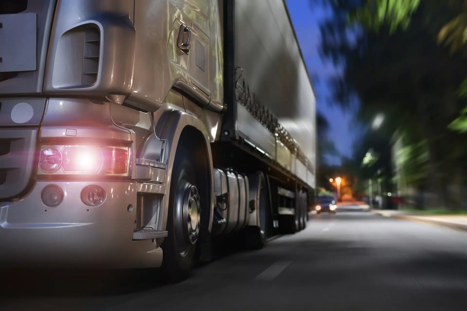 truck drives on a night road; concept Commercial Trucking Accident