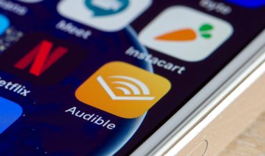 Audible mobile app icon is seen on a smartphone.