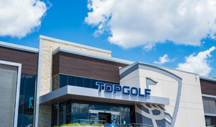 Signage on the exterior front of the Topgolf location in West Chester in a blue sky/mostly sunny day.