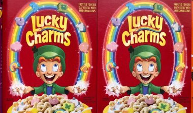 Boxes of General Mills Lucky Charms cereal on super market shelf.