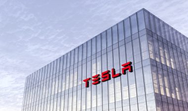 Tesla Signage Logo on Top of Glass Building. Workplace Car Company Office Headquarter.