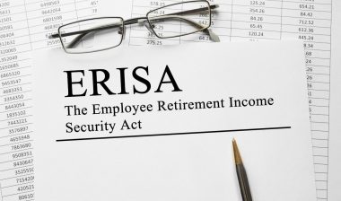 Paper with Employee Retirement Income Security Act ERISA on a table