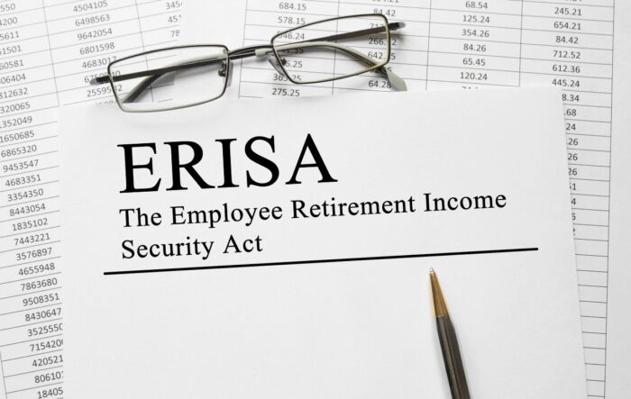 Paper with Employee Retirement Income Security Act ERISA on a table