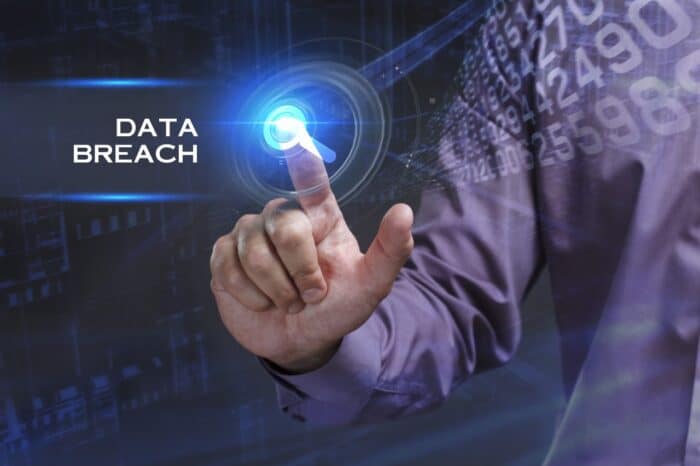 Young businessman working on a virtual screen of the future and sees the inscription: Data breach - bosley class action lawsuit
