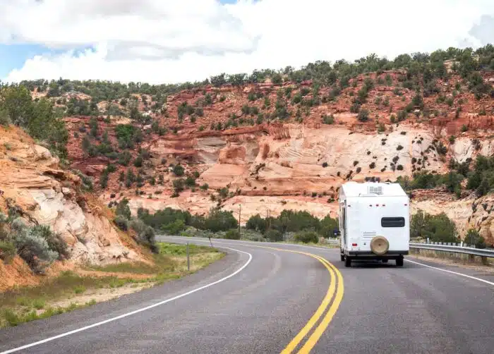 Traveling trailer driving down the road - forest river