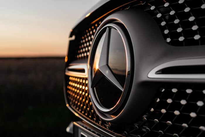 Mercedes car against a sunset sky.