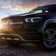 Photo of Mercedes SUV against a sunset sky.