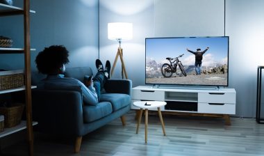 African American Streaming And Watching Movie On TV Screen.
