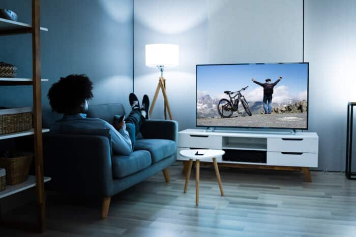 African American Streaming And Watching Movie On TV Screen.