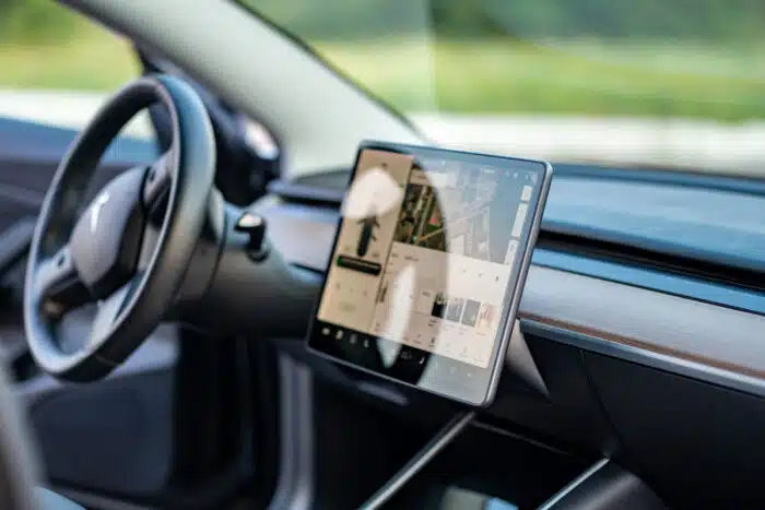 Photo of Tesla interior displaying infotainment center.