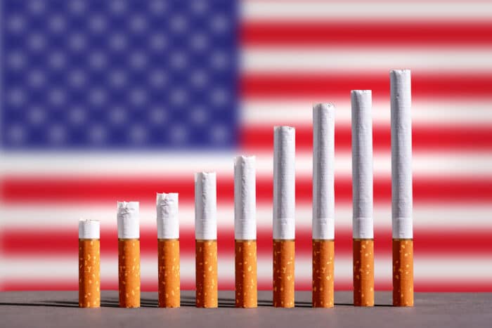 Cigarettes in front of a United States flag.
