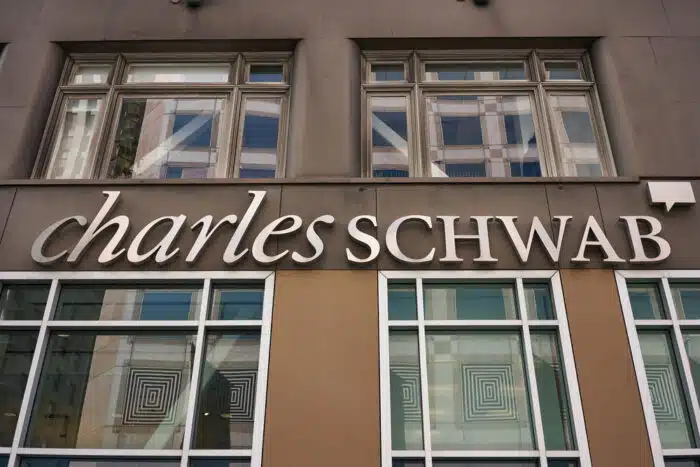 The Charles Schwab logo is seen at a location of the American bank and stock brokerage firm in the SoMa District of San Francisco - robo-adviser, sec