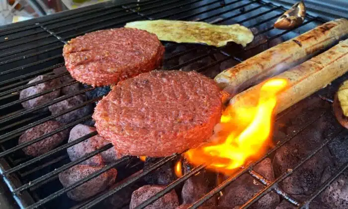 Two Beyond Meat patties cooking on a grill - false advertising class action