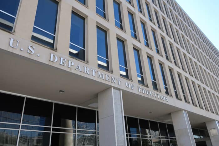 US DEPARTMENT OF EDUCATION sign on headquarters building exterior.