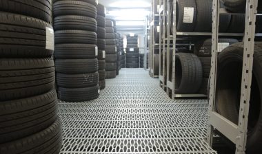 Stacks of new tires in a tire shop.