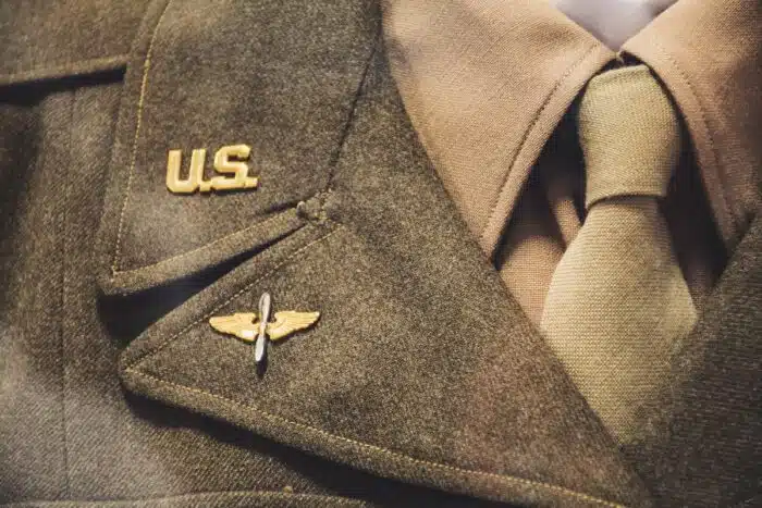 Gold-colored U.S. Brooch on military uniform.