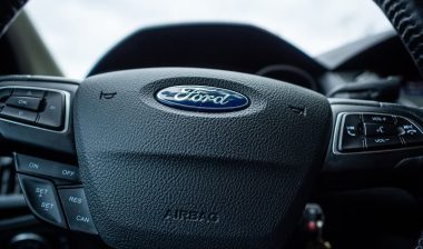 Close up of Ford emblem on a steering wheel.
