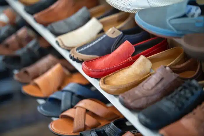A variety of shoes displayed on shelves inside a shoe store - TCPA - text messages