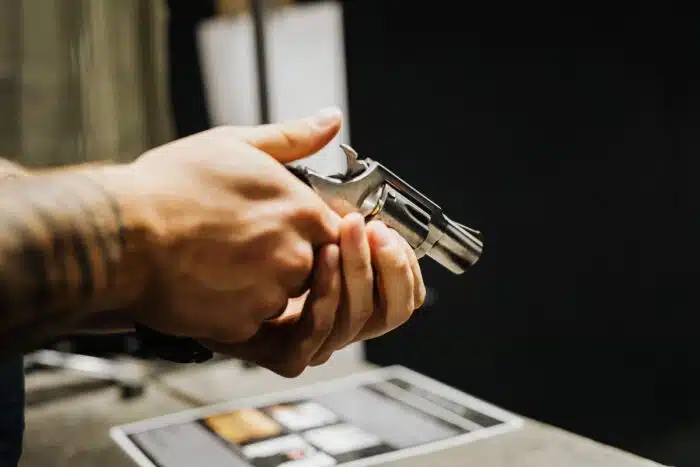 Person holding a silver handgun.