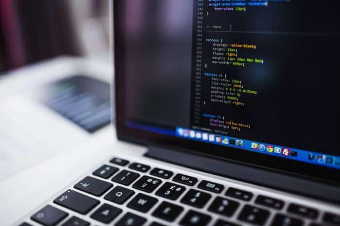 Close up of a laptop screen displaying lines of code for web building/design - ADA, website, blind, accessibility