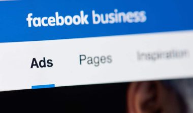 Facebook business page for advertising on laptop screen close-up.