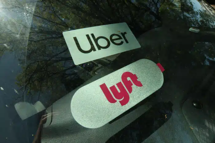 Close up of Uber and Lyft sticker on a car windshield.