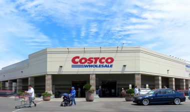 Exterior of a Costco wholesale store against a blue sky.