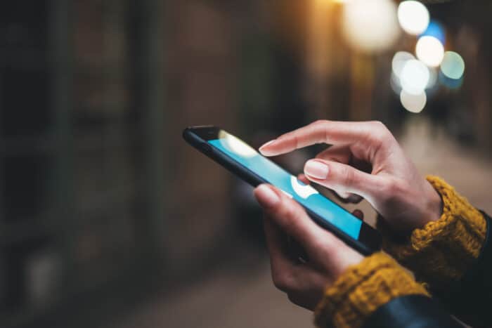 Close up of hand using smartphone.