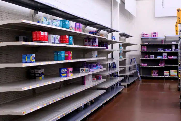 Empty grocery shelves inside of a market.