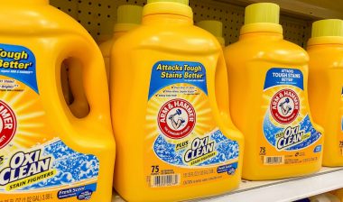 Bottles of Arm and Hammer Laundry Detergent on a store shelf.