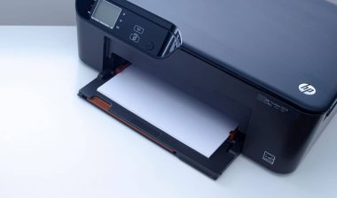 An HP Deskjet 3522 e-All-in-One Printer on a white table.