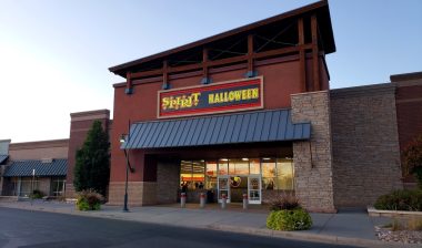 Exterior of Spirit Halloween store in Loveland, Colorado against a blue sky.