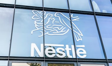 Close up of Nestle logo on an exterior glass building.