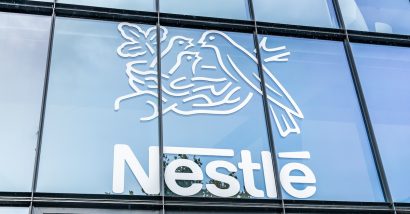 Close up of Nestle logo on an exterior glass building.
