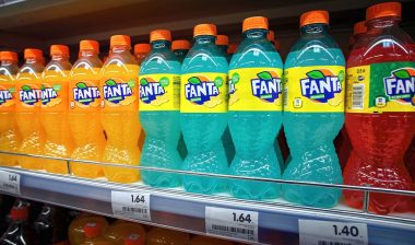 Fanta in plastic bottles display on shelf for sale in supermarket.