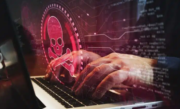 Skull pirate, online cyberattack, hack, threat and breach security symbol and man typing computer keyboard - abs data security incident settlement, american bank systems data breach
