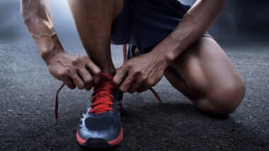 Man tying running shoes.