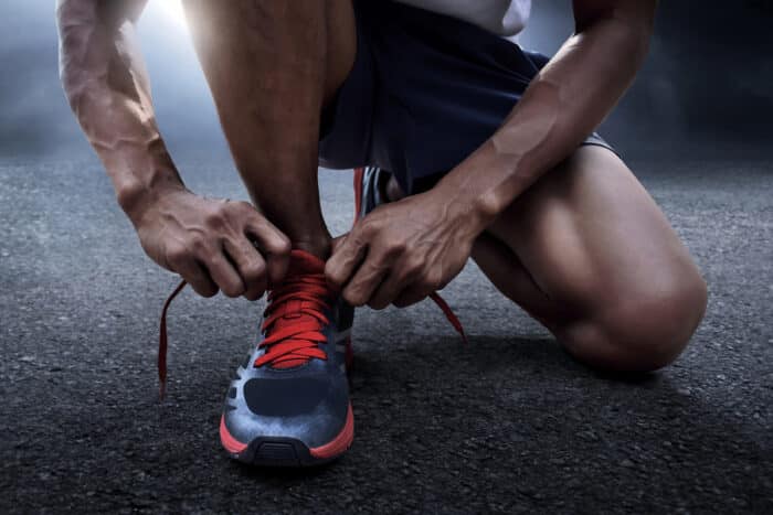 Man tying running shoes - Gravity Defyer - ftc - pain relief